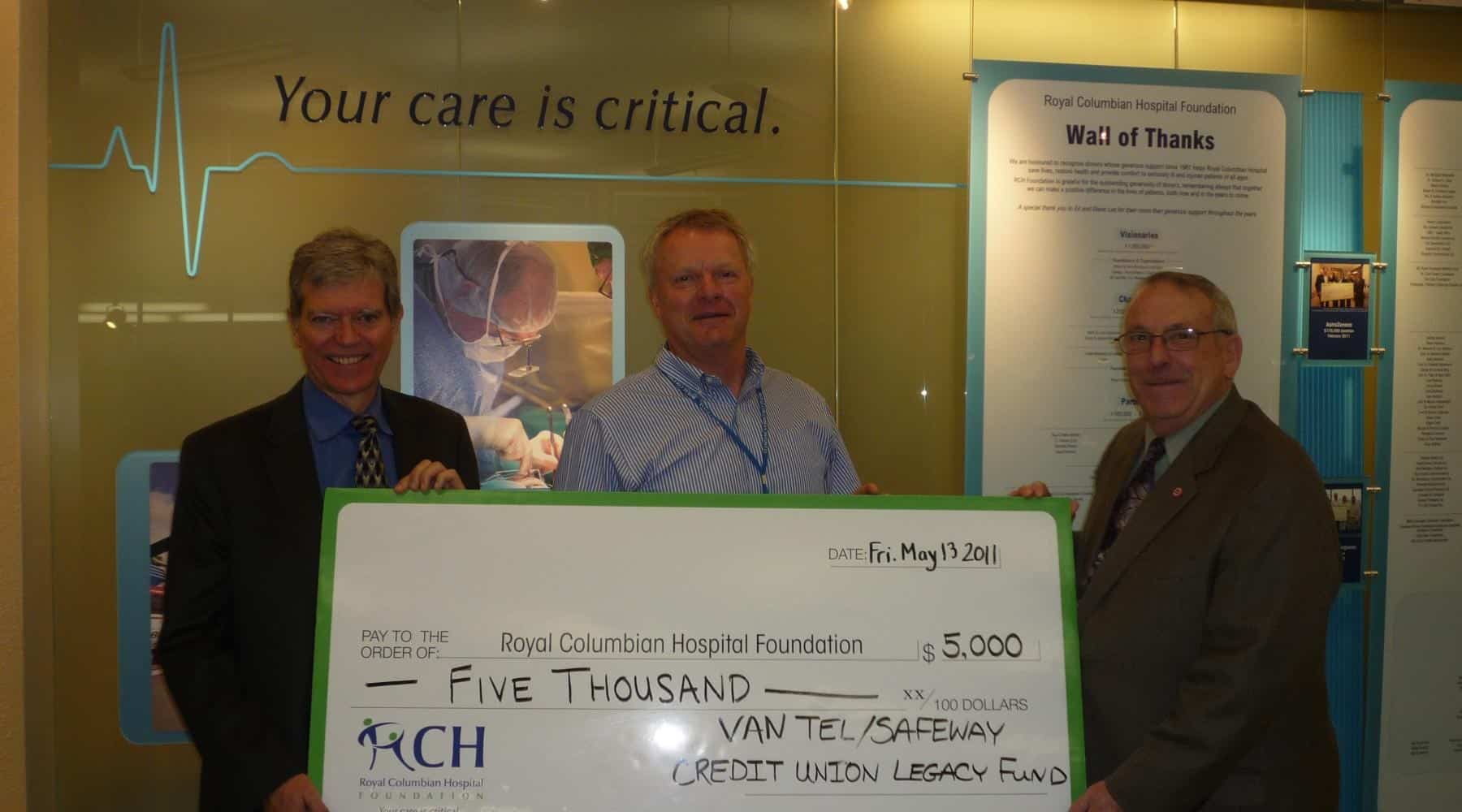 Three men presenting a $5,000 donation cheque to the Royal Columbian Hospital Foundation