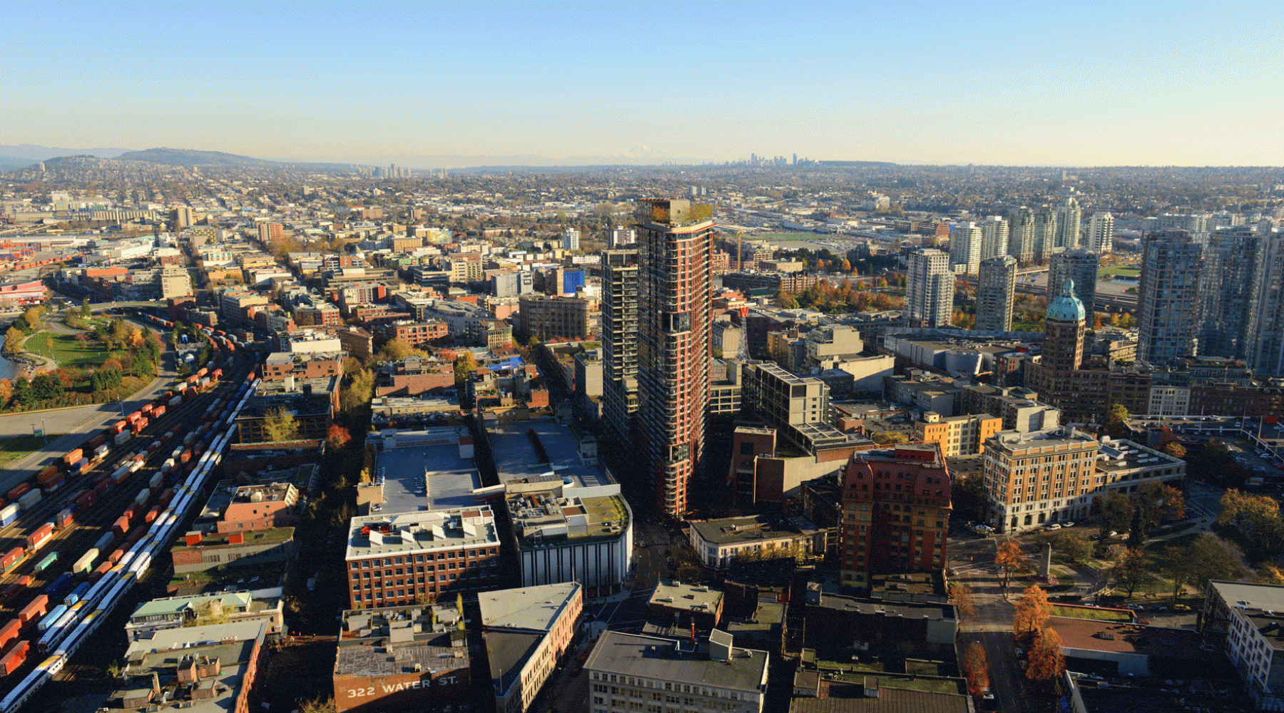 Aerial view of a dense urban neighbourhood with high-rise buildings and rail lines