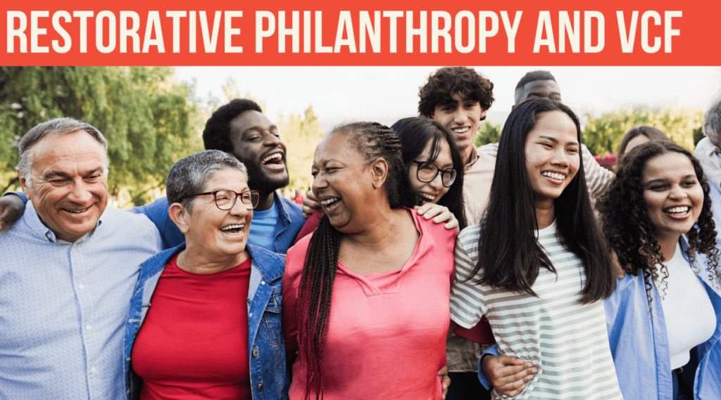Diverse group of people smiling together under a banner reading “Restorative Philanthropy and VCF.”