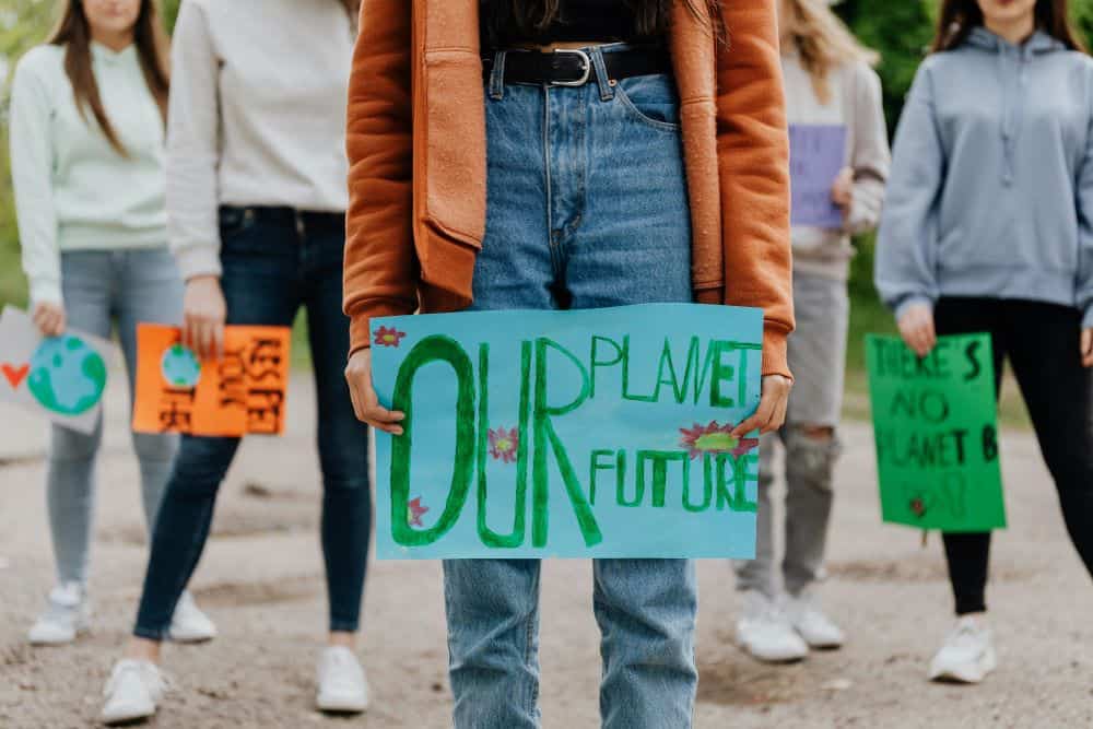 Youth climate activists holding signs during an environmental protest