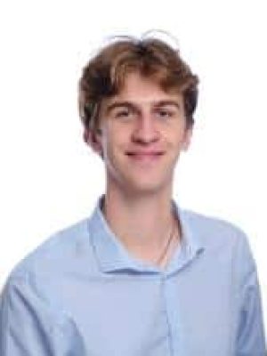 Smiling young man in a light blue shirt.